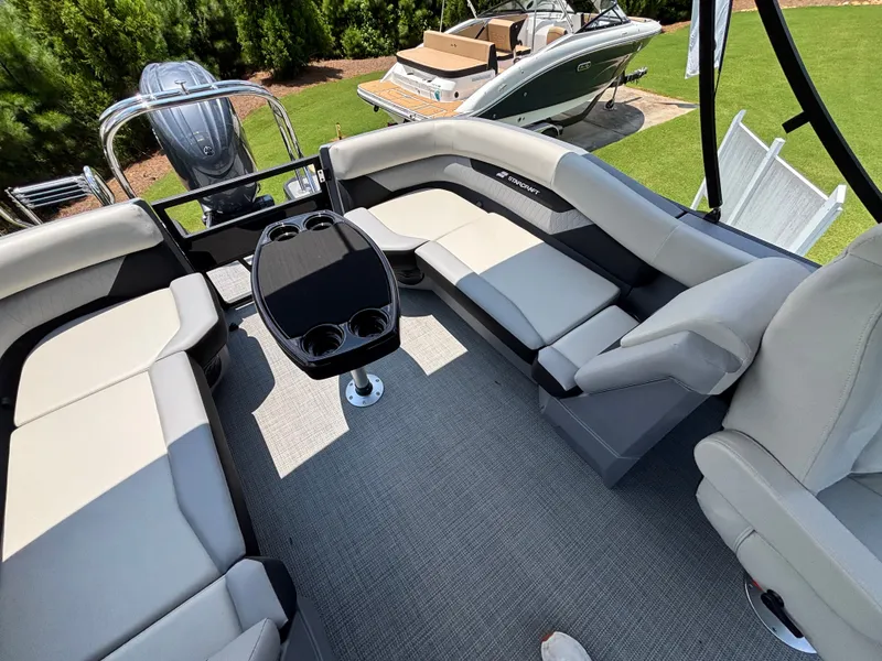 Slide: The Image of Interior of a Starcraft VX 22 R DH with gray seating and a table. - 12