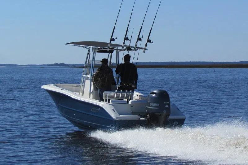 Slide: The Image of 2026 Bulls Bay 200 Center Console boat with Yamaha engine on trailer, under clear sky. - 2