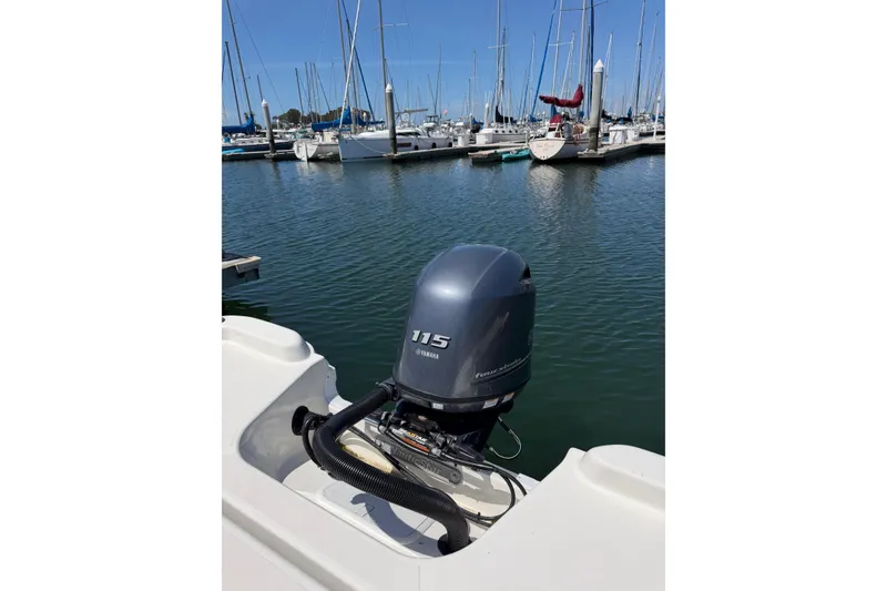 Slide: The Image of 2023 NauticStar 211 Hybrid boat with Yamaha 115 engine at marina. - 13