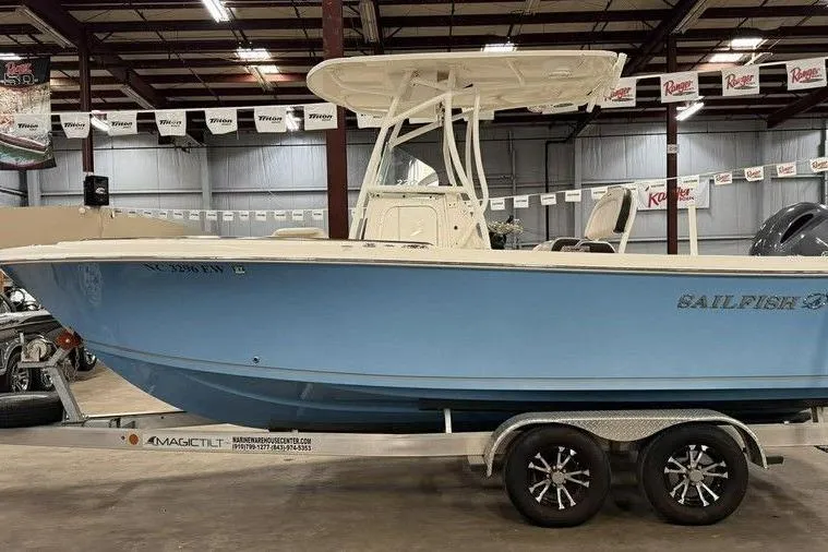 The Image of 2022 Sailfish 220 CC boat on trailer in indoor showroom. - 1