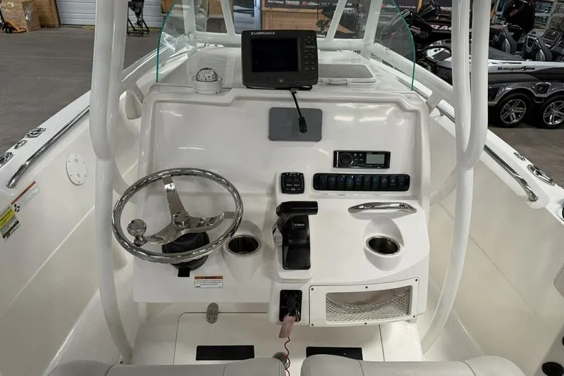Slide: The Image of 2022 Sailfish 220 CC boat console with steering wheel, controls, and navigation equipment. - 3