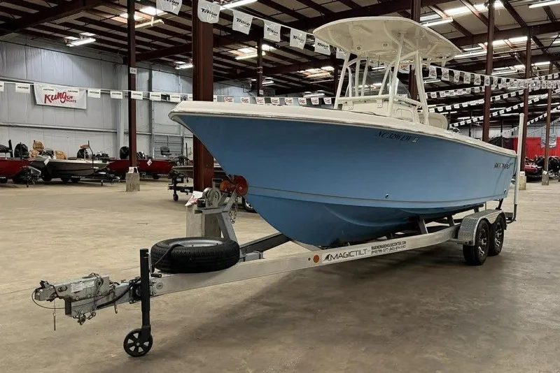 Slide: The Image of 2022 Sailfish 220 CC boat on trailer in indoor showroom. - 4