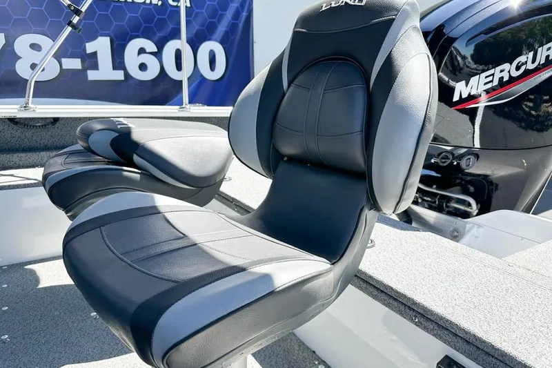 Slide: The Image of 2026 Lund 1700 Explorer Sport boat seat with Mercury engine in background. - 26
