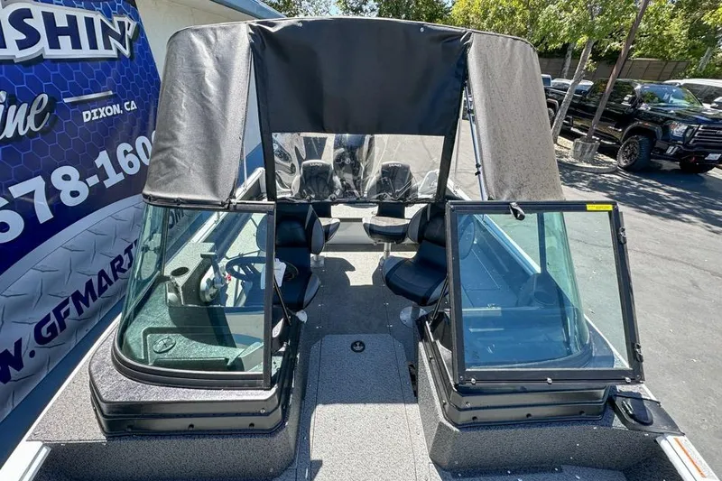 Slide: The Image of 2026 Lund 1700 Explorer Sport boat with canopy, parked outdoors. - 20