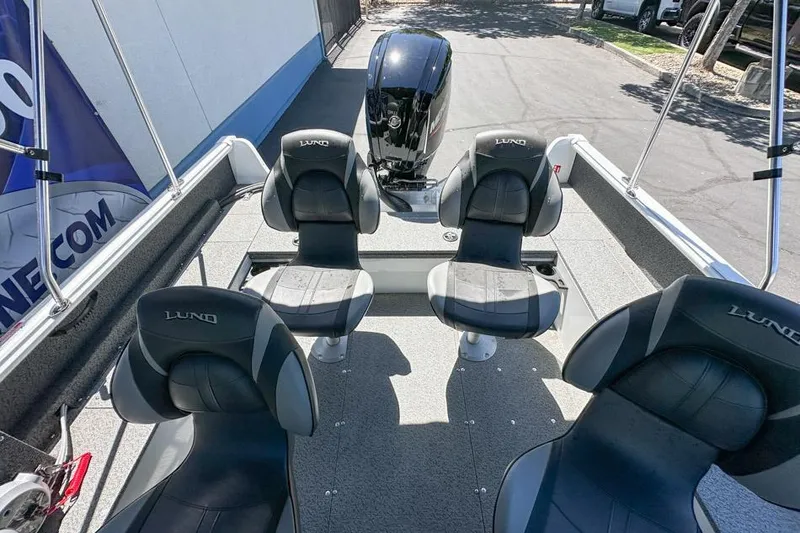 Slide: The Image of 2026 Lund 1700 Explorer Sport boat interior with four seats and motor. - 16