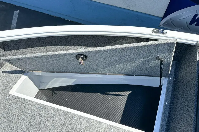 Slide: The Image of Open storage compartment on 2026 Lund 1700 Explorer Sport boat deck. - 19