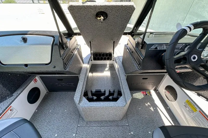 Slide: The Image of Interior view of 2026 Lund 1700 Explorer Sport boat, featuring storage compartments and steering wheel. - 15