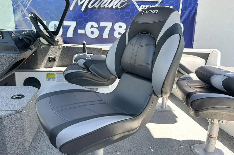 Slide: The Image of 2026 Lund 1700 Explorer Sport boat interior with comfortable seating and steering wheel. - 25