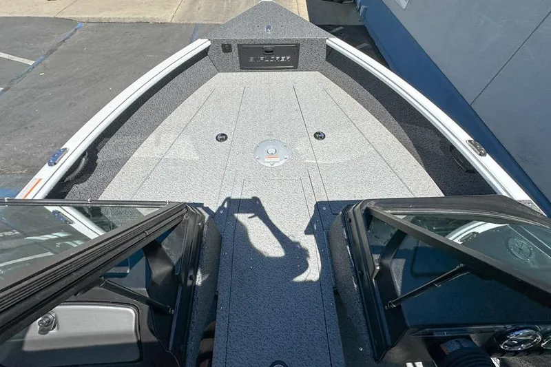 Slide: The Image of 2026 Lund 1700 Explorer Sport boat deck with windshield and storage compartments. - 17