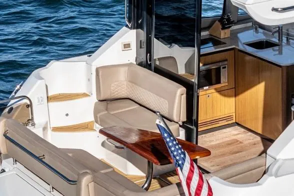 Slide: The Image of Luxurious 2017 Sea Ray 460 Sundancer yacht interior with seating and kitchenette. - 2