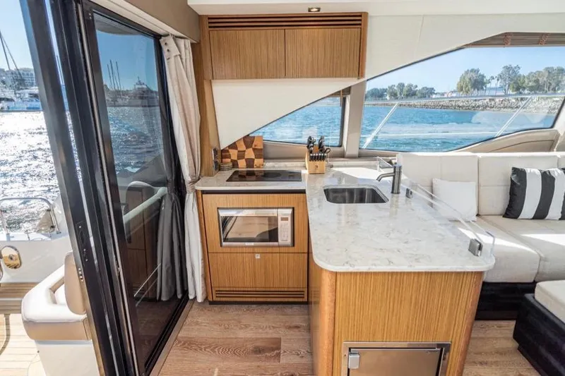 Slide: The Image of Luxurious 2017 Sea Ray 460 Sundancer yacht interior with modern kitchen and ocean view. - 7