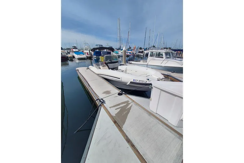 The Image of 2021 Zodiac N-ZO 680 boat docked at a marina with other vessels. - 0