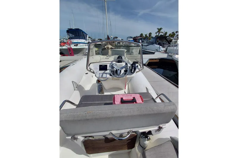 Slide: The Image of 2021 Zodiac N-ZO 680 boat interior with steering wheel and dashboard at marina. - 4