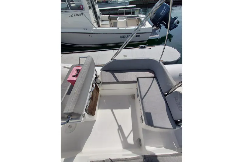 Slide: The Image of 2021 Zodiac N-ZO 680 boat interior with gray seating and visible outboard motor. - 6