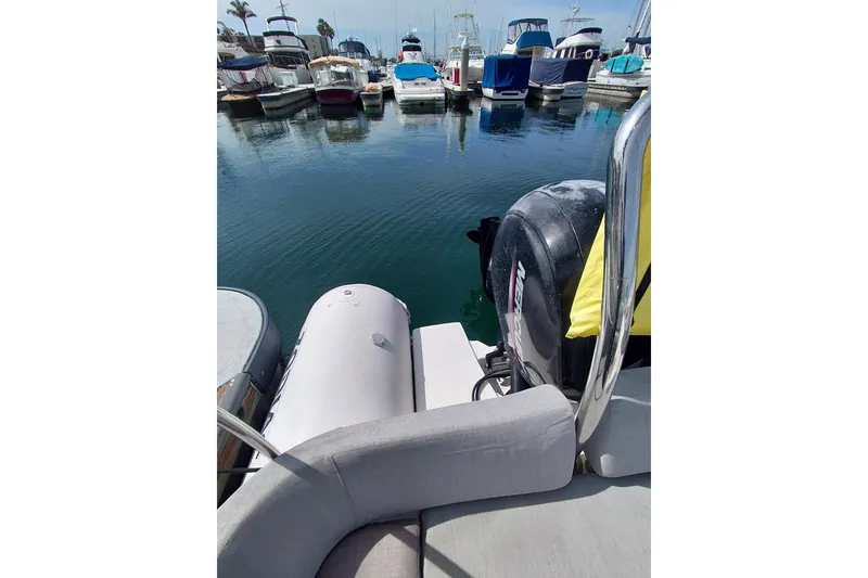 Slide: The Image of 2021 Zodiac N-ZO 680 boat docked in a marina with other vessels. - 8