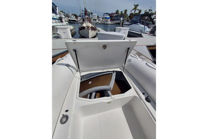 Slide: The Image of Open storage compartment on a 2021 Zodiac N-ZO 680 boat at a marina. - 9