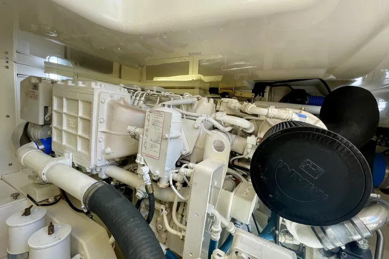 Slide: The Image of Engine room of a 2006 Cabo 40 Flybridge boat, showcasing mechanical components. - 103