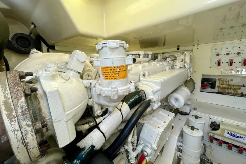 Slide: The Image of Engine room of a 2006 Cabo 40 Flybridge boat, showcasing mechanical components. - 105