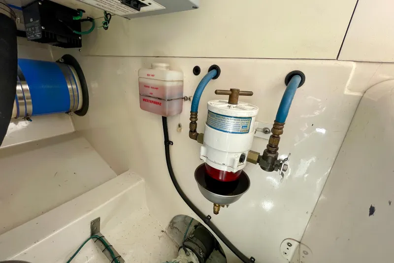 Slide: The Image of Engine compartment of 2006 Cabo 40 Flybridge with fuel filter and Westerbeke coolant reservoir. - 106