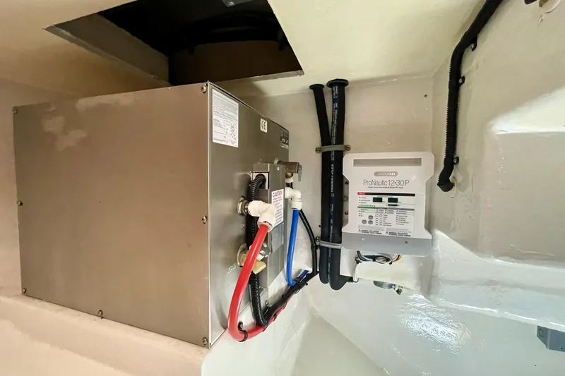 Slide: The Image of Electrical system inside a 2006 Cabo 40 Flybridge boat, featuring ProNautic12-30P charger. - 108