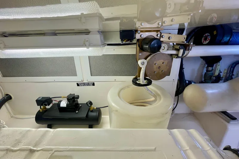 Slide: The Image of Engine room of a 2006 Cabo 40 Flybridge boat, showcasing mechanical components. - 109