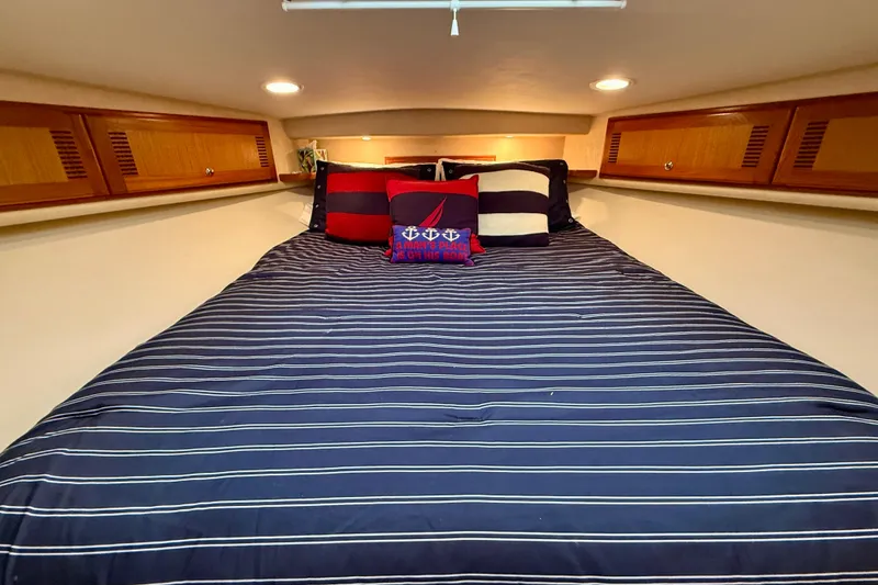 Slide: The Image of Luxurious cabin interior of 2006 Cabo 40 Flybridge yacht with striped bedding. - 12