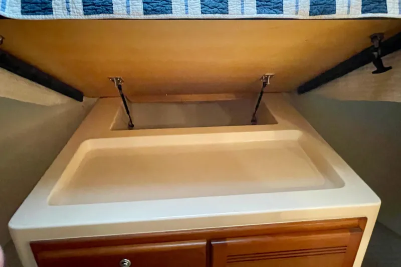 Slide: The Image of Under-bed storage compartment in a 2006 Cabo 40 Flybridge yacht. - 13