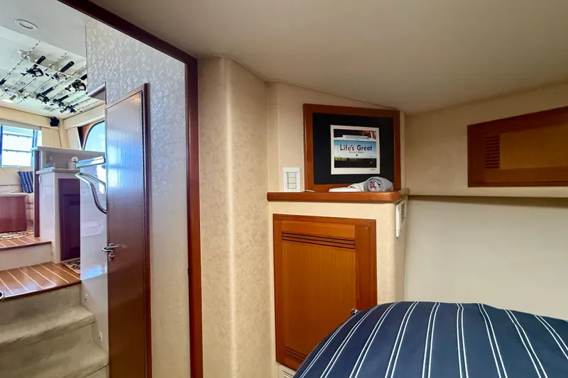 Slide: The Image of Interior of 2006 Cabo 40 Flybridge yacht with cozy cabin and framed decor. - 14
