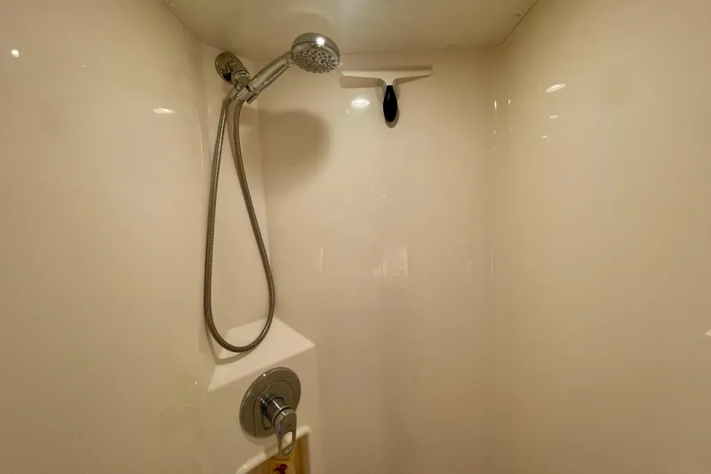 Slide: The Image of Shower area in 2006 Cabo 40 Flybridge yacht, featuring handheld showerhead. - 16