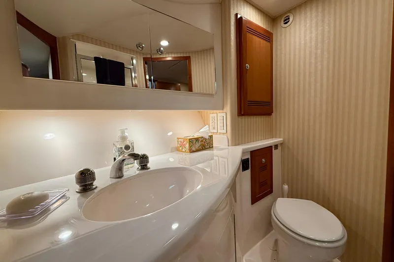 Slide: The Image of Luxurious bathroom in 2006 Cabo 40 Flybridge yacht with modern fixtures and elegant design. - 17