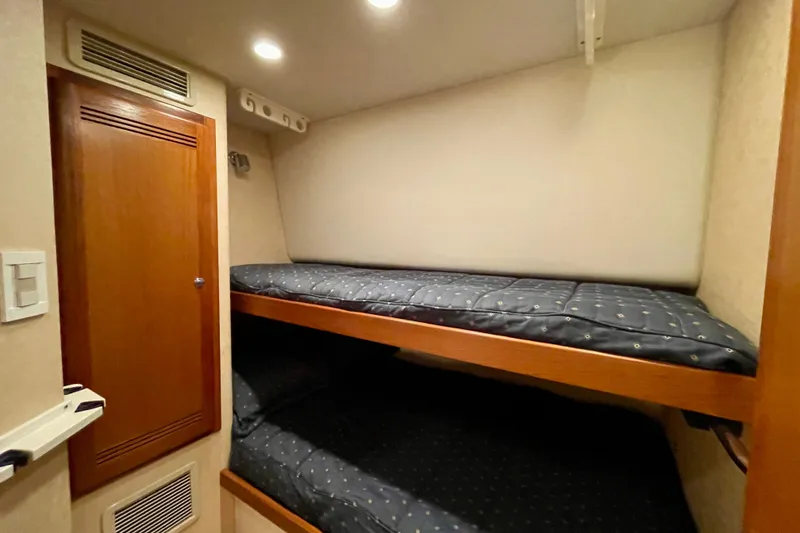 Slide: The Image of 2006 Cabo 40 Flybridge cabin with bunk beds and wooden cabinetry. - 19