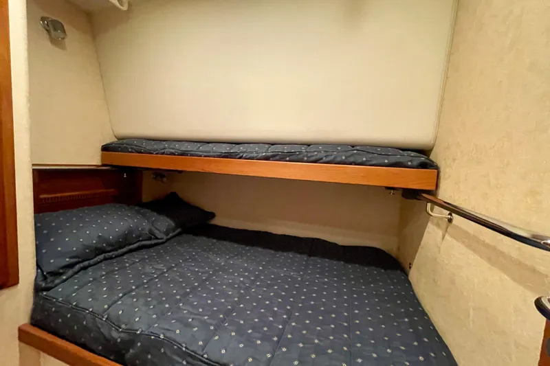 Slide: The Image of Bunk beds in 2006 Cabo 40 Flybridge yacht cabin with blue bedding. - 20