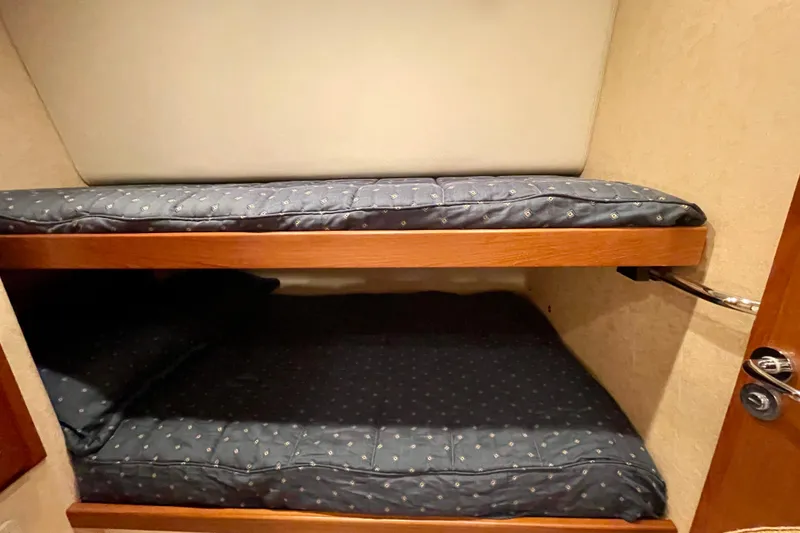 Slide: The Image of Bunk beds in 2006 Cabo 40 Flybridge yacht cabin with blue bedding. - 21