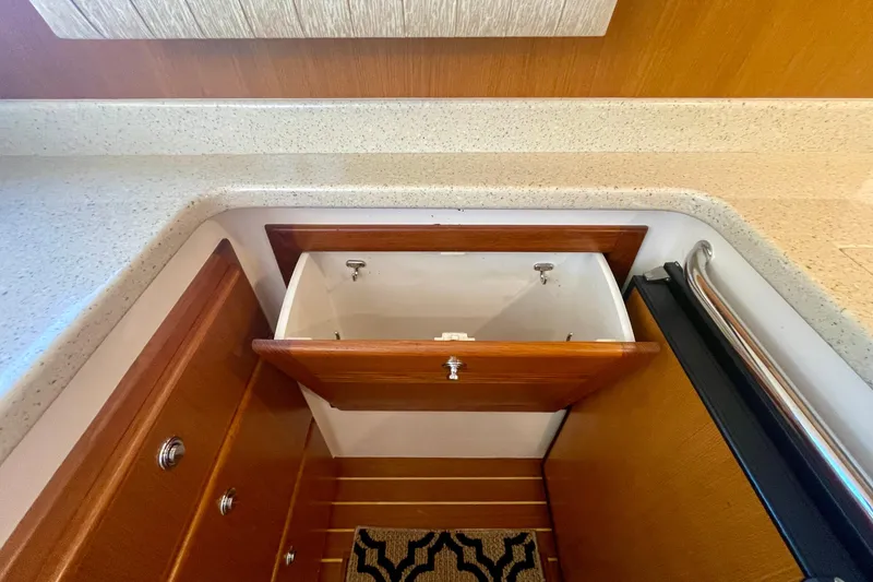 Slide: The Image of Open drawer in 2006 Cabo 40 Flybridge yacht kitchen with wood finish. - 25