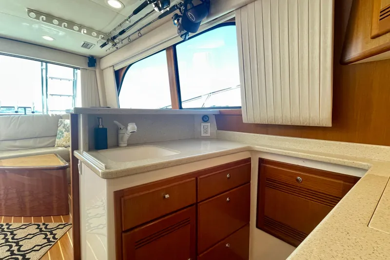 Slide: The Image of Luxurious 2006 Cabo 40 Flybridge yacht interior with modern kitchen and seating area. - 29