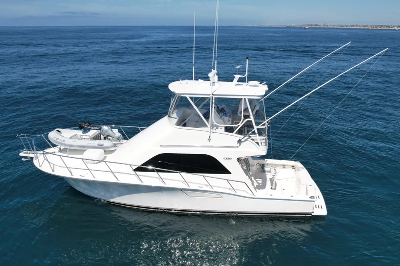 Slide: The Image of 2006 Cabo 40 Flybridge yacht cruising on open blue ocean waters. - 3