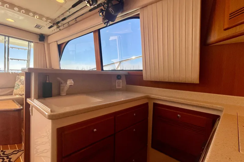 Slide: The Image of Interior of 2006 Cabo 40 Flybridge yacht with kitchenette and seating area. - 31