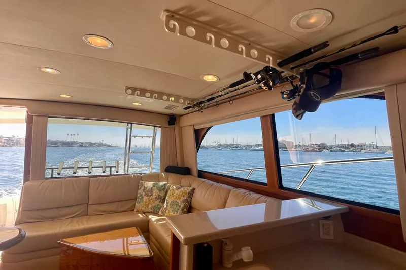 Slide: The Image of Luxurious interior of 2006 Cabo 40 Flybridge yacht with ocean view and fishing rods. - 33