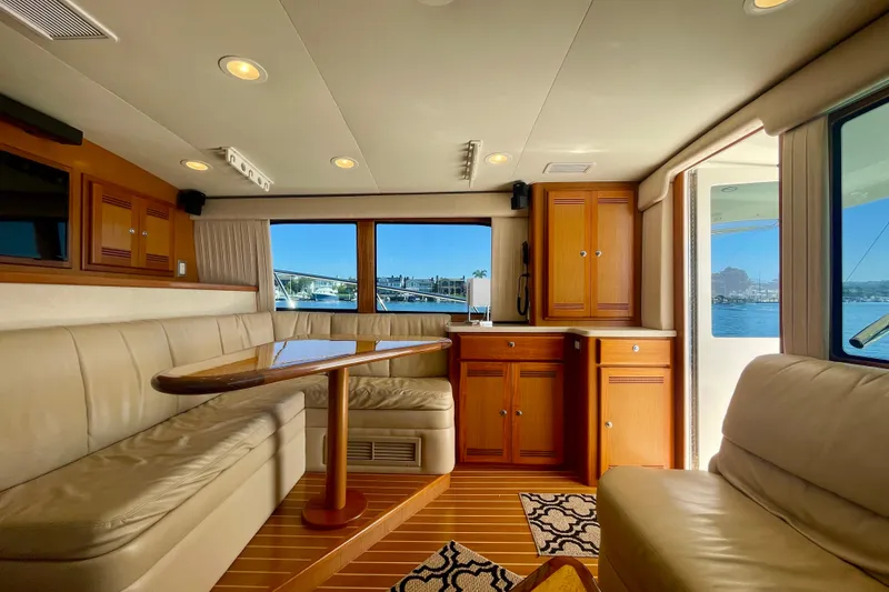 Slide: The Image of Luxurious interior of a 2006 Cabo 40 Flybridge yacht with elegant wood cabinetry and seating. - 37