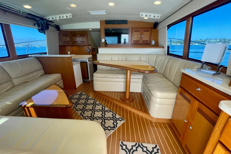 Slide: The Image of Luxurious interior of a 2006 Cabo 40 Flybridge yacht with elegant seating and wood finishes. - 39