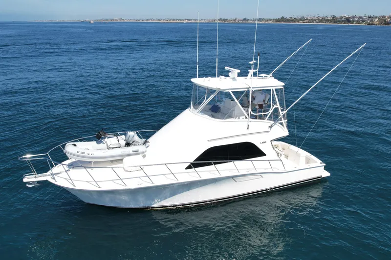 Slide: The Image of 2006 Cabo 40 Flybridge yacht cruising on open blue ocean waters. - 4