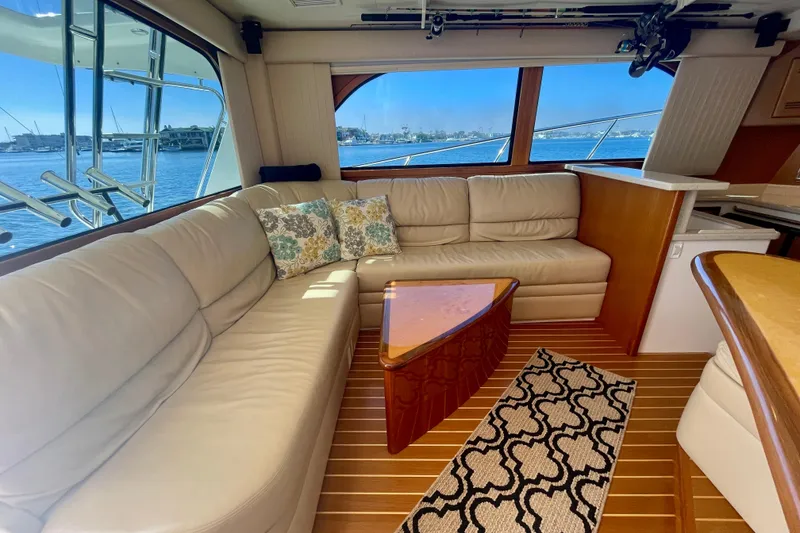 Slide: The Image of Luxurious 2006 Cabo 40 Flybridge yacht interior with plush seating and scenic ocean view. - 40