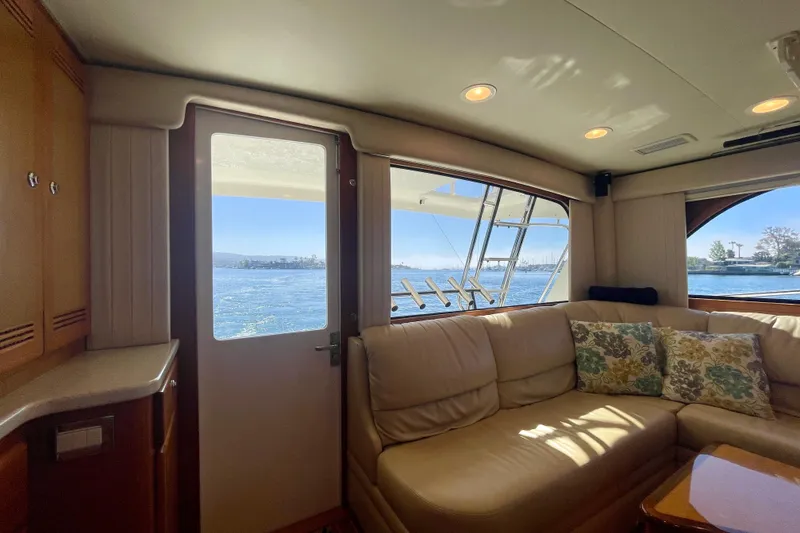 Slide: The Image of Interior of 2006 Cabo 40 Flybridge yacht with ocean view through door. - 42