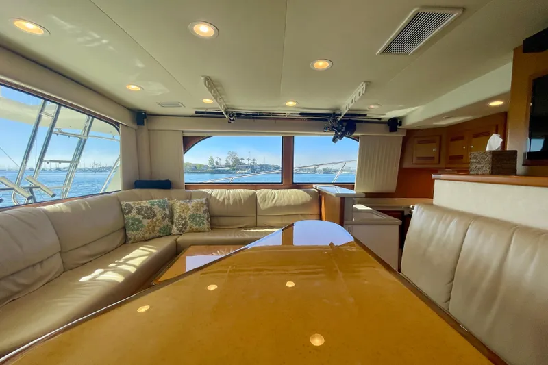 Slide: The Image of Luxurious interior of 2006 Cabo 40 Flybridge yacht with plush seating and scenic windows. - 43