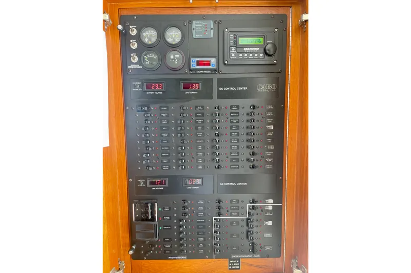 Slide: The Image of Electrical control panel of a 2006 Cabo 40 Flybridge yacht, featuring gauges and switches. - 45