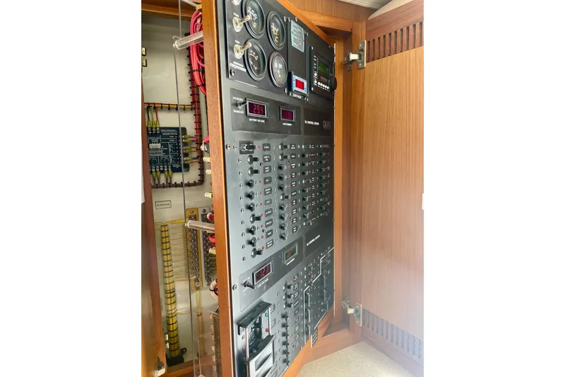 Slide: The Image of Electrical panel inside a 2006 Cabo 40 Flybridge boat, showcasing gauges and switches. - 47