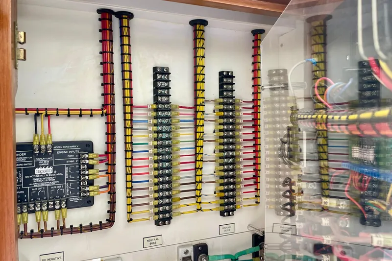 Slide: The Image of Electrical panel with organized wiring in a 2006 Cabo 40 Flybridge boat. - 48