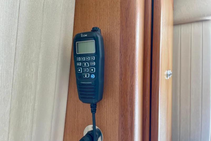 Slide: The Image of Icom CommandMic mounted on 2006 Cabo 40 Flybridge interior wooden panel. - 50