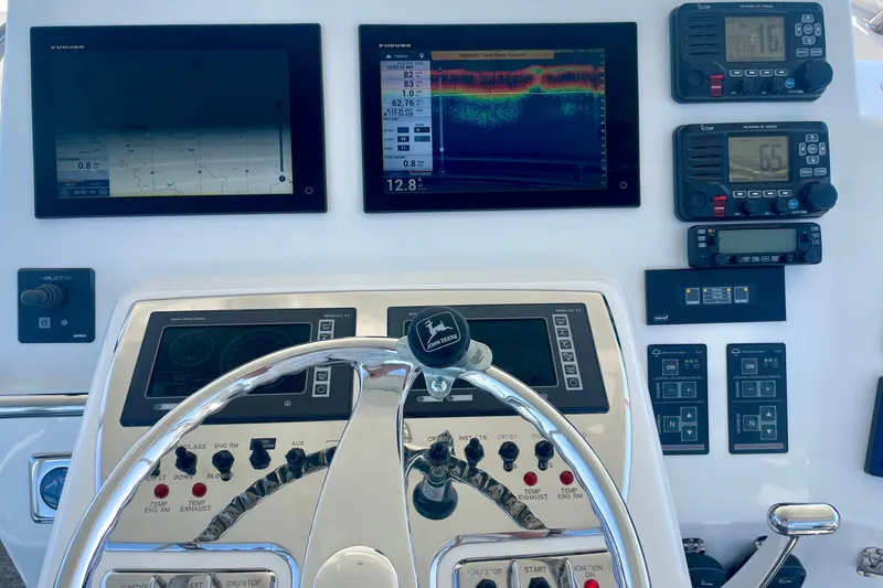 Slide: The Image of Helm of 2006 Cabo 40 Flybridge with navigation and communication equipment. - 52