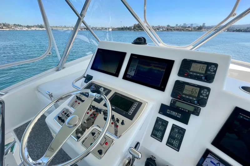 Slide: The Image of Helm of 2006 Cabo 40 Flybridge yacht with navigation instruments and ocean view. - 54